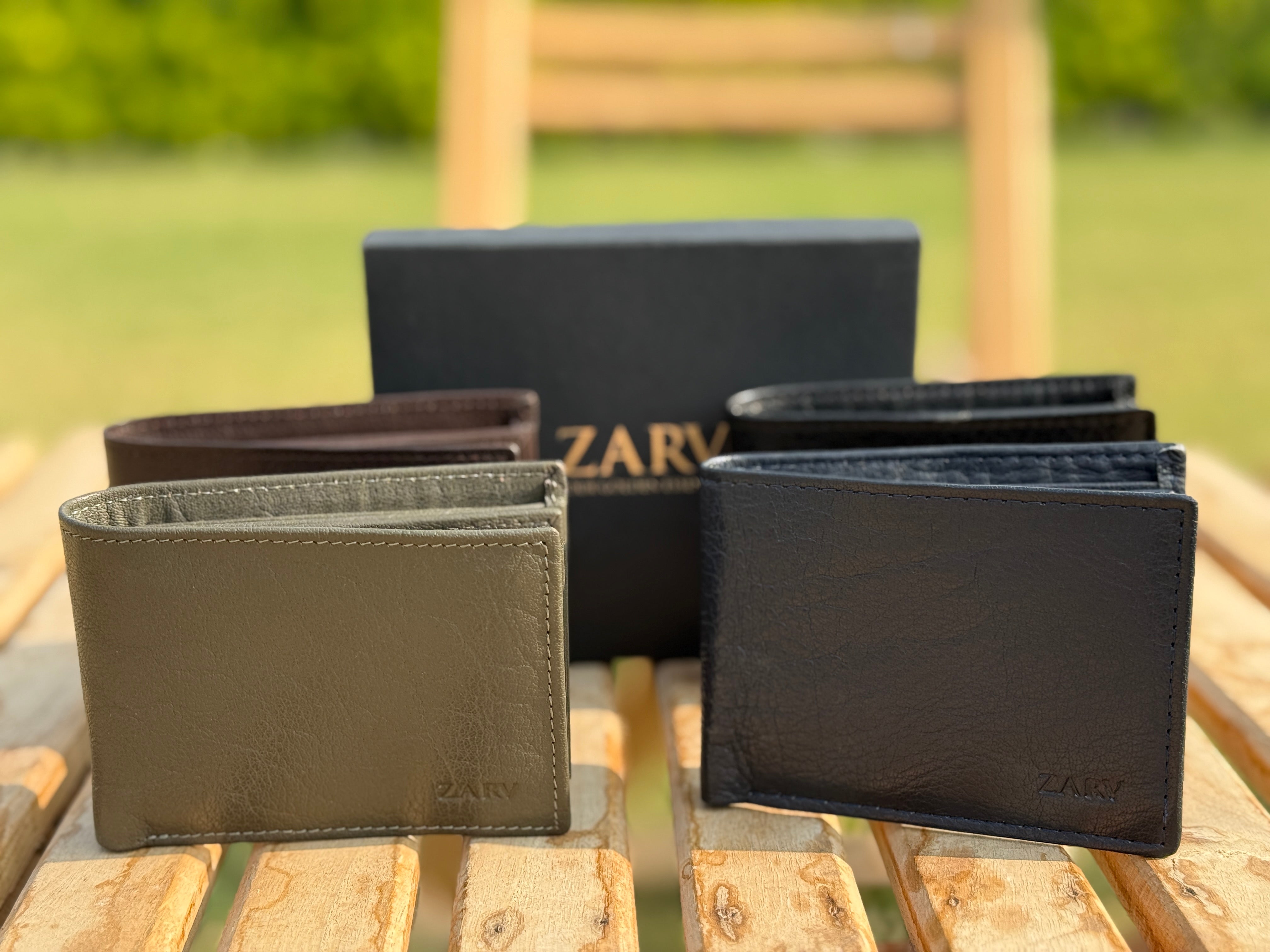 Collection of ZARY wallets on a wooden surface with a blurred natural background